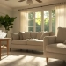 Salon lumineux en été avec rideaux légers et fenêtres ouvertes laissant entrer la brise naturelle, illustrant des astuces naturelles pour rafraîchir son intérieur.
